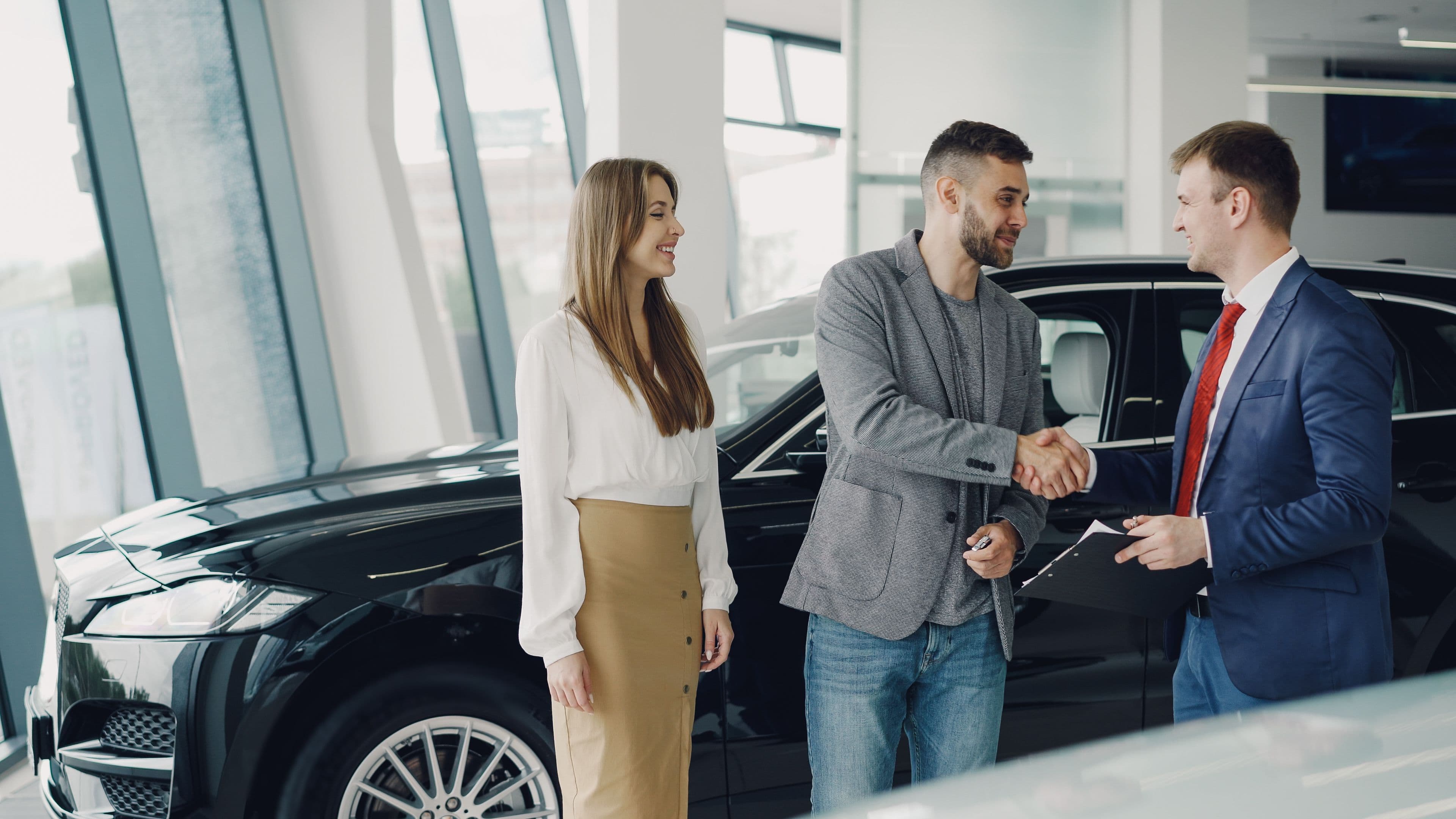 Sales rep reviewing a verified DriveIQ lead notification on a dealership floor